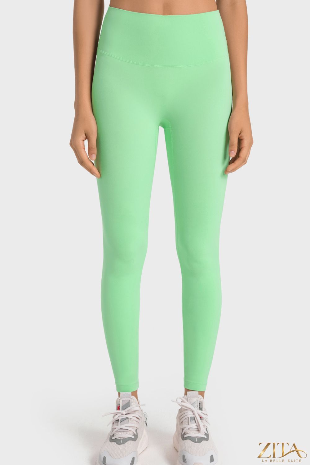 Millennia high-rise yoga leggings with wide waistband from Trendsi, shown in black, designed for comfort and flexibility during exercise.