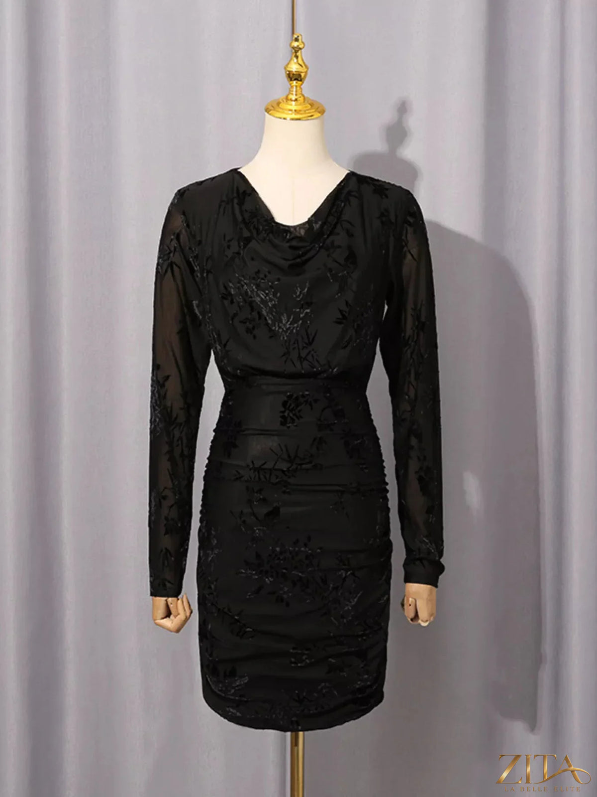 Ruched long sleeve mini dress by Trendsi, featuring a fitted silhouette and stylish design, shown in a close-up view.