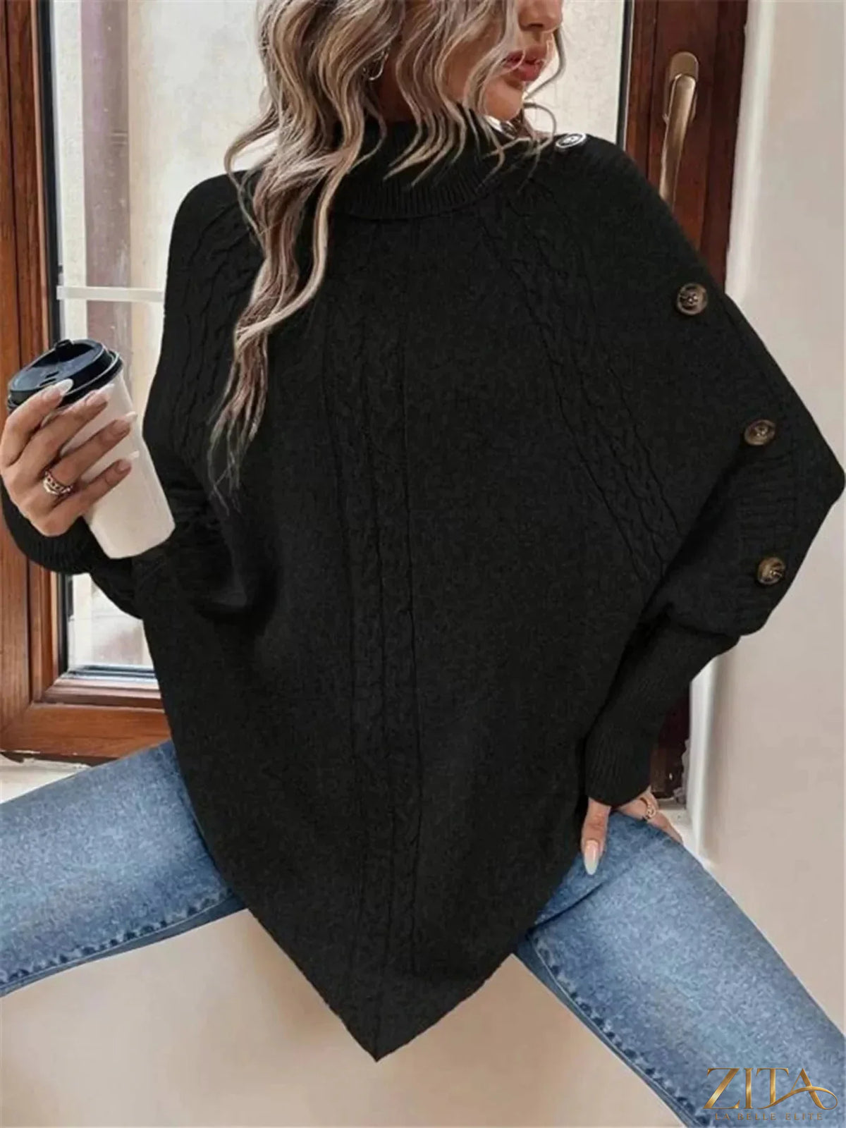 Cable knit turtleneck cape sweater from Trendsi featuring a cozy, textured design with a high neck and flowing cape style.