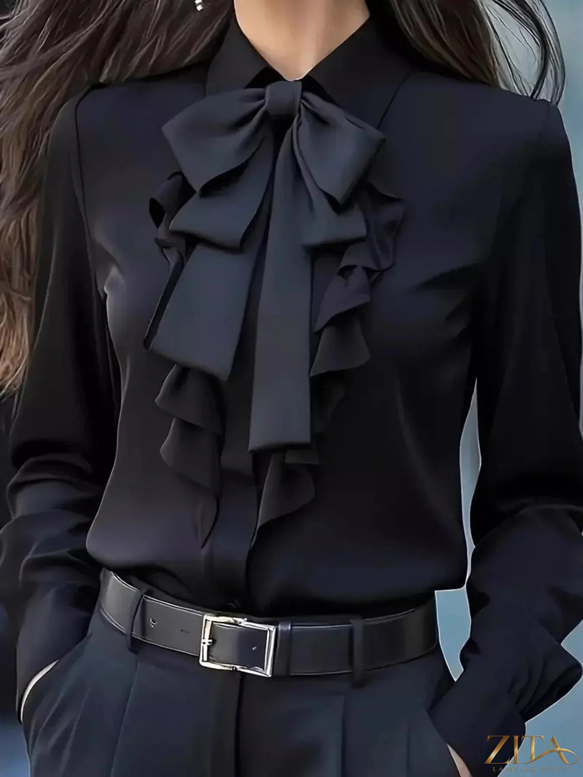 Zita La Belle Elite ruffled tie-front long sleeve blouse with feminine details and soft fabric, displayed on a hanger.