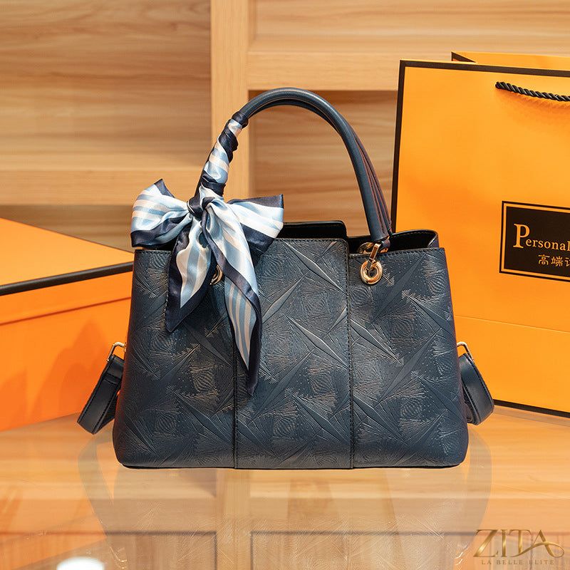 Zita La Belle Elite top-handle handbag in sleek black leather, featuring gold-tone hardware and a structured design.