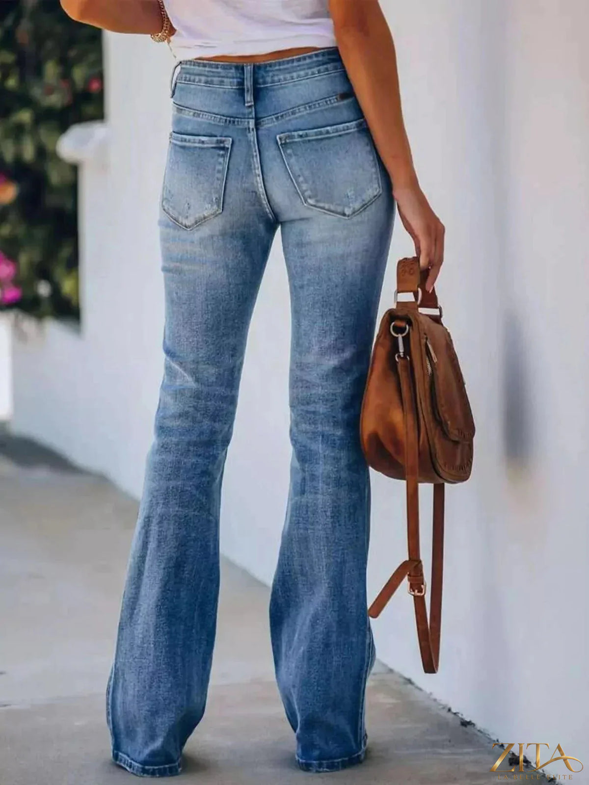 High-waisted flare jeans by Zita La Belle Elite featuring a fitted waist and wide flared legs, displayed on a model.