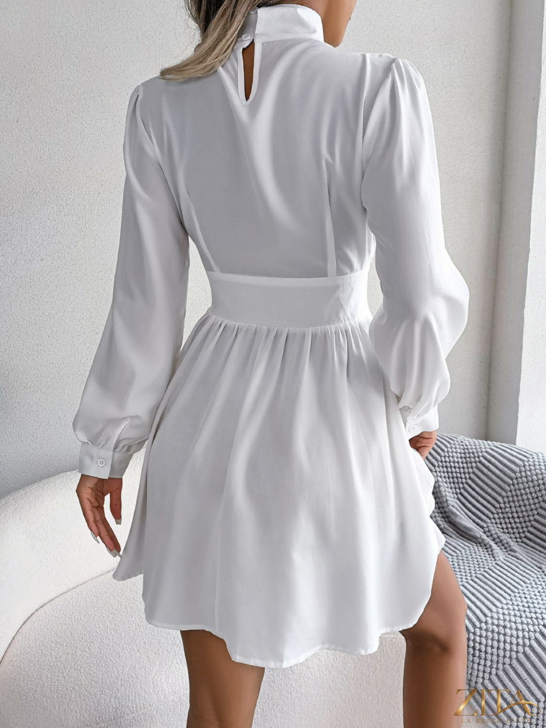 Black cutout turtleneck A-line mini dress from Trendsi, featuring a fitted turtleneck and flared hem, perfect for stylish occasions.