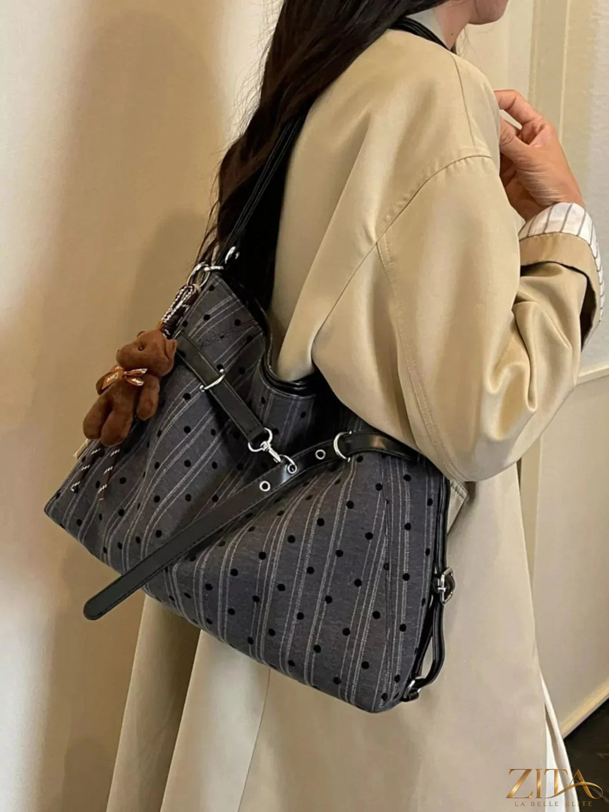 Zita La Belle Elite polka dot shoulder bag with adjustable strap and zipper closure, featuring a stylish black and white polka dot pattern.