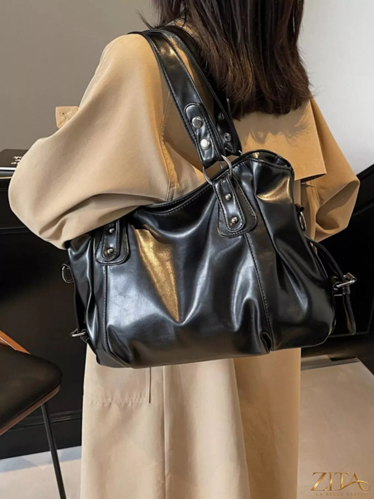 Vintage style leather handbag from Trendsi with sturdy handles and classic design, featuring a rich brown leather finish.