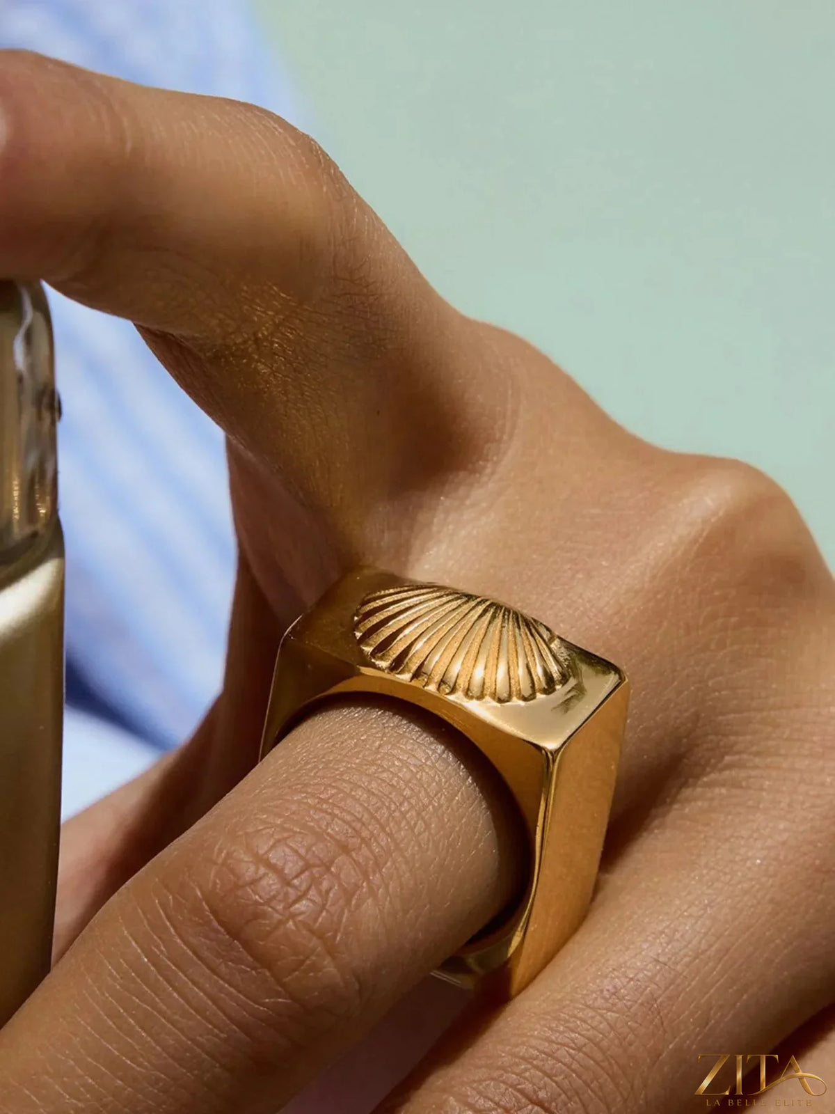 Vintage shell pattern gold signet ring by Zita La Belle Elite, showcasing intricate shell design on polished gold band.