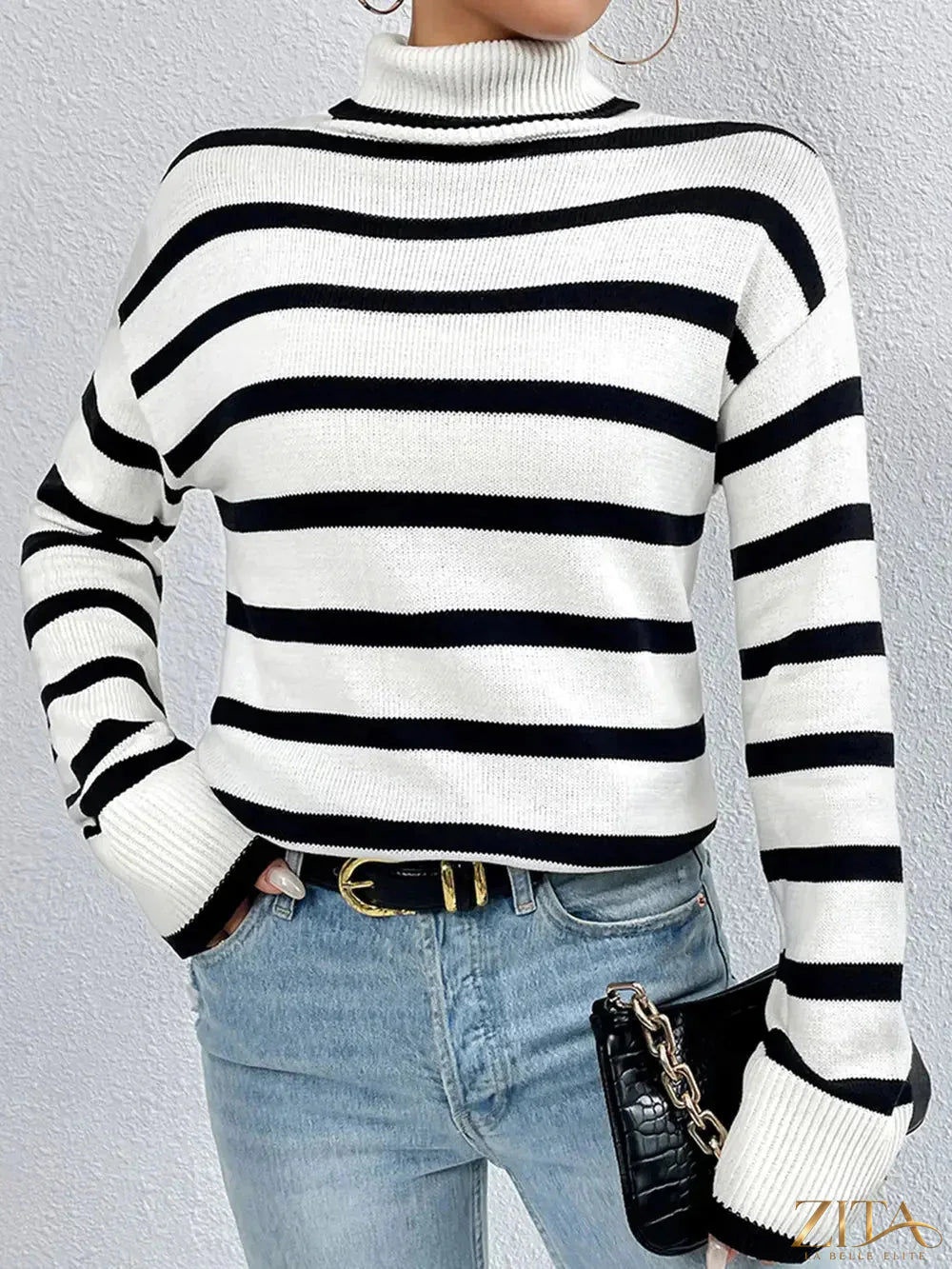 Striped turtleneck long sleeve sweater by Trendsi, featuring a cozy knit design with bold horizontal stripes in various colors.