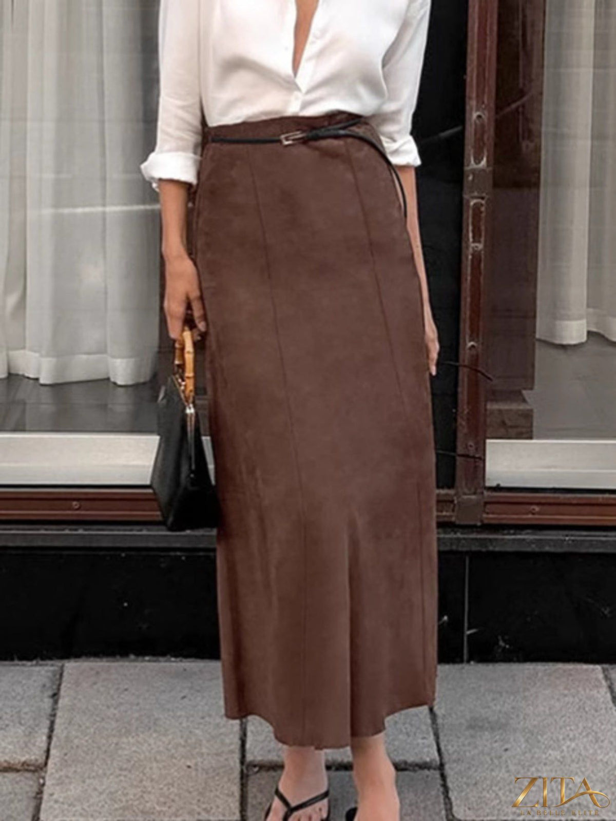Trendsi suede midi skirt in soft tan, high-waisted with a flowy silhouette and smooth texture, shown on a model.