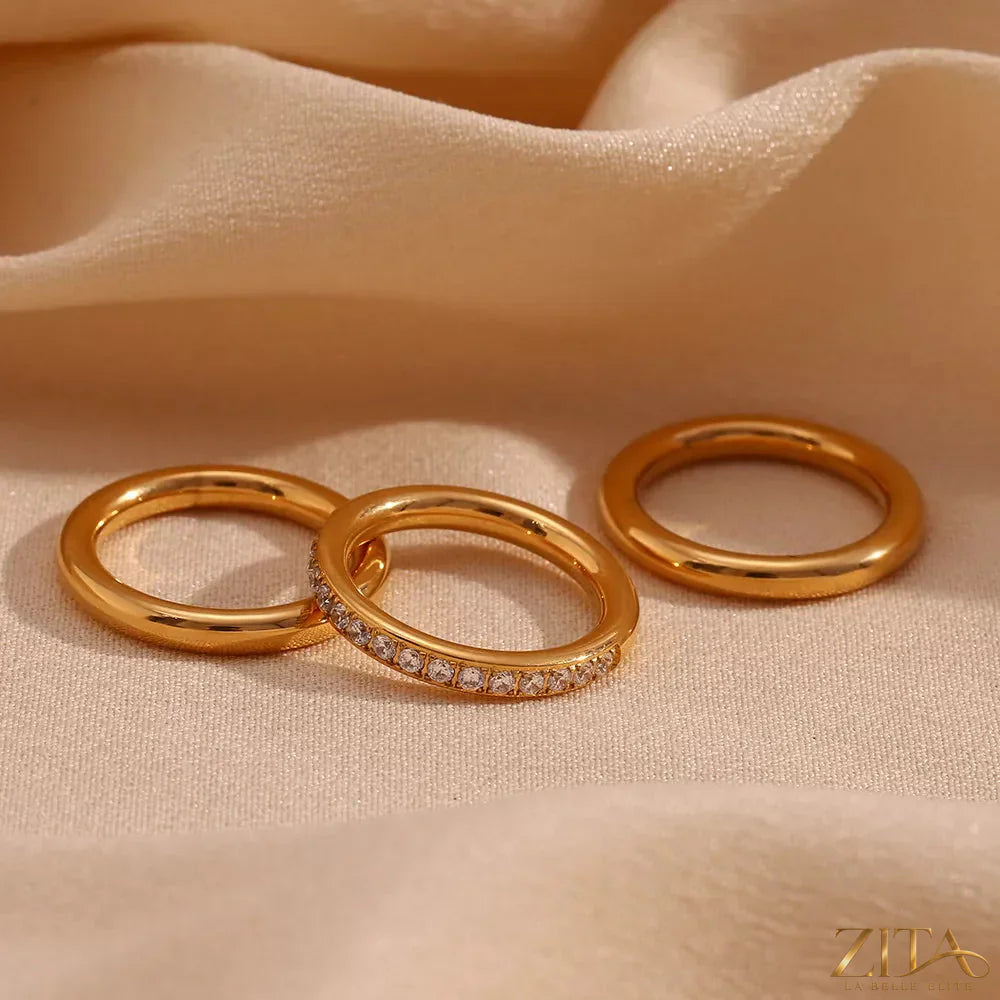 Three stainless steel zircon rings from Zita La Belle Elite, showcasing different band designs in a close-up image.