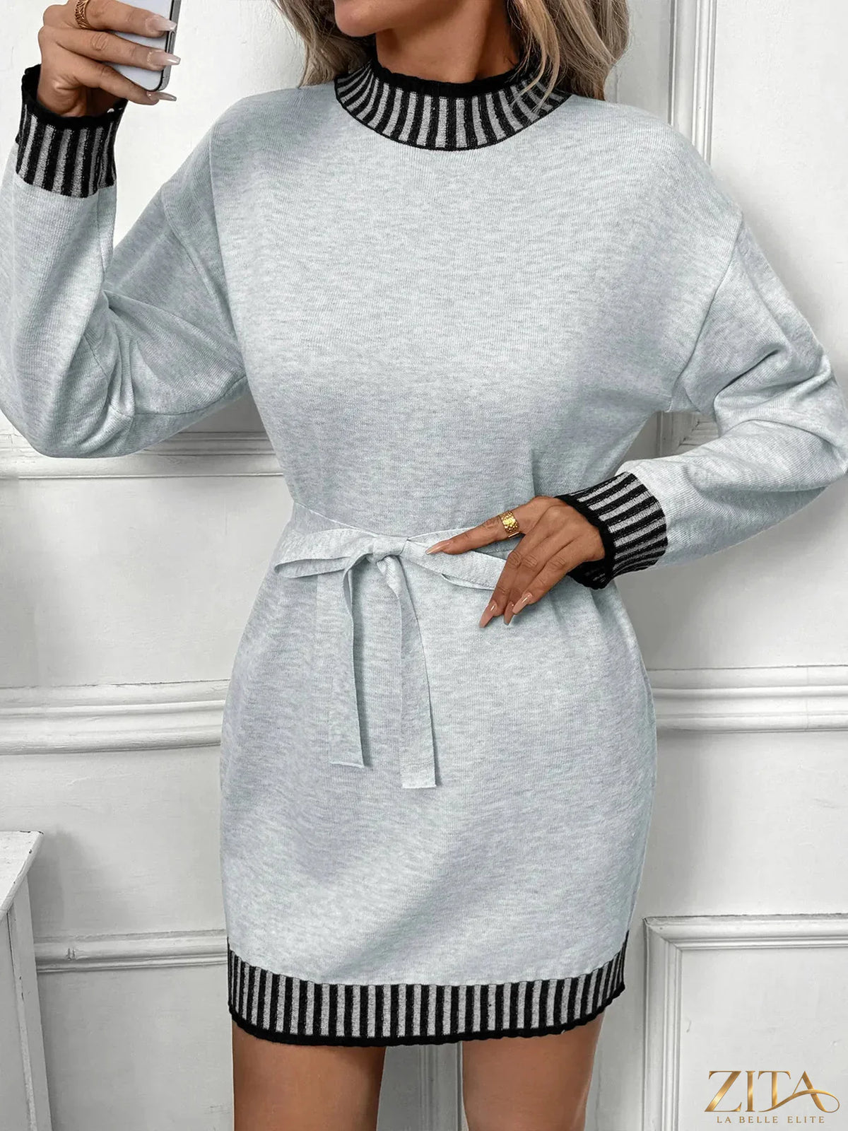 Zita La Belle Elite striped trim tie waist sweater dress with long sleeves and a fitted silhouette on a model.