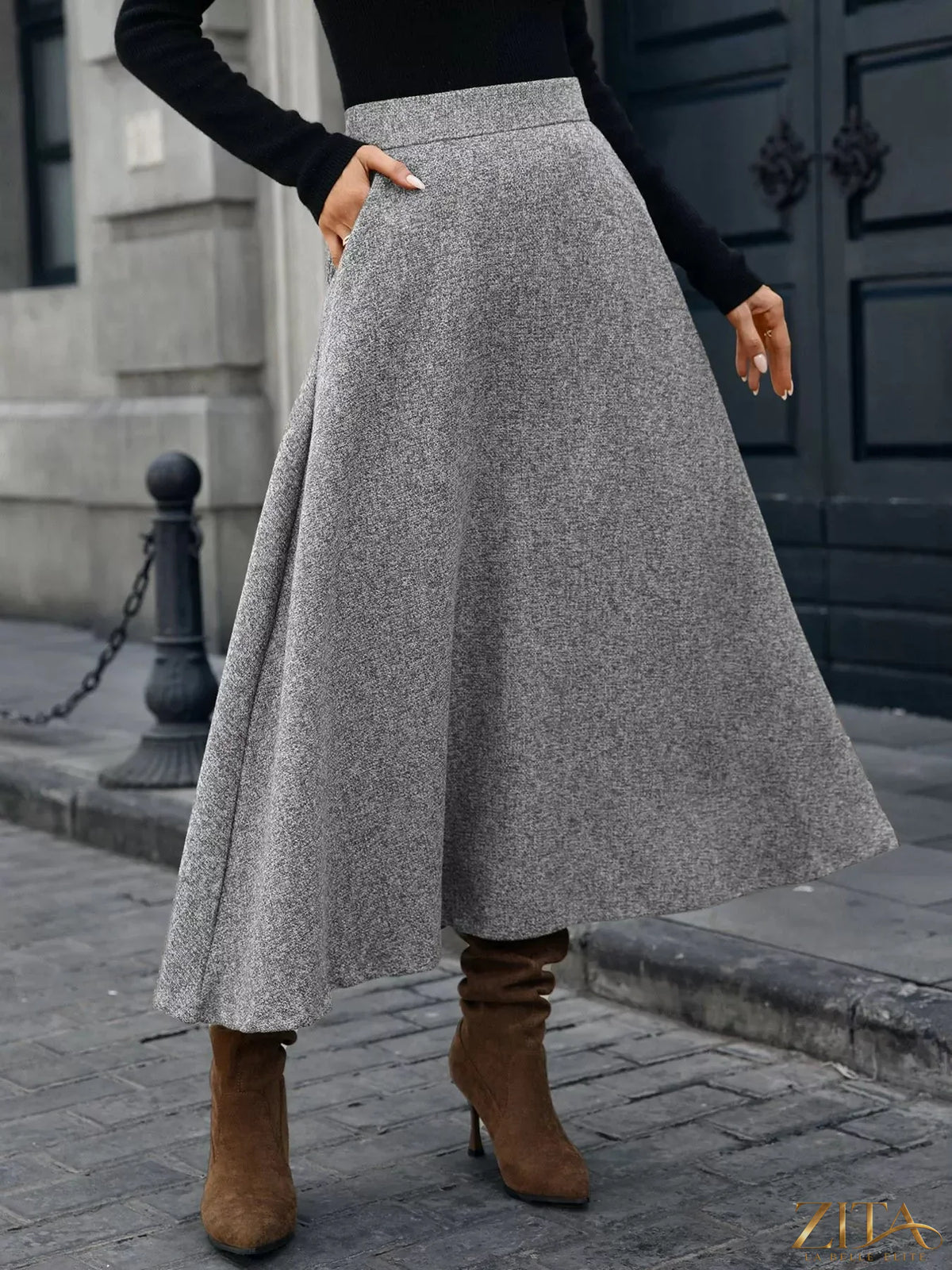 Light blue A-line midi skirt from Trendsi, flowing fabric, high waist, and knee-length design shown on a model.
