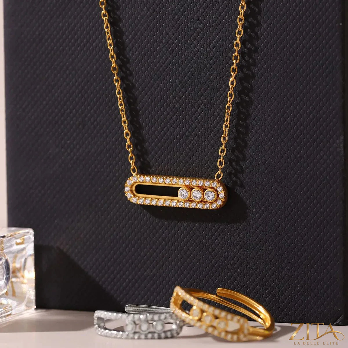 Moving crystal bar necklace and ring jewelry set featuring sparkling stones and sleek silver designs, stylish and elegant.