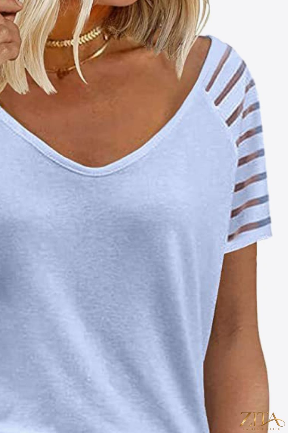 V-Neck Raglan Sleeve Tee by Trendsi, featuring a casual fit with contrasting sleeves and a soft fabric for everyday wear.
