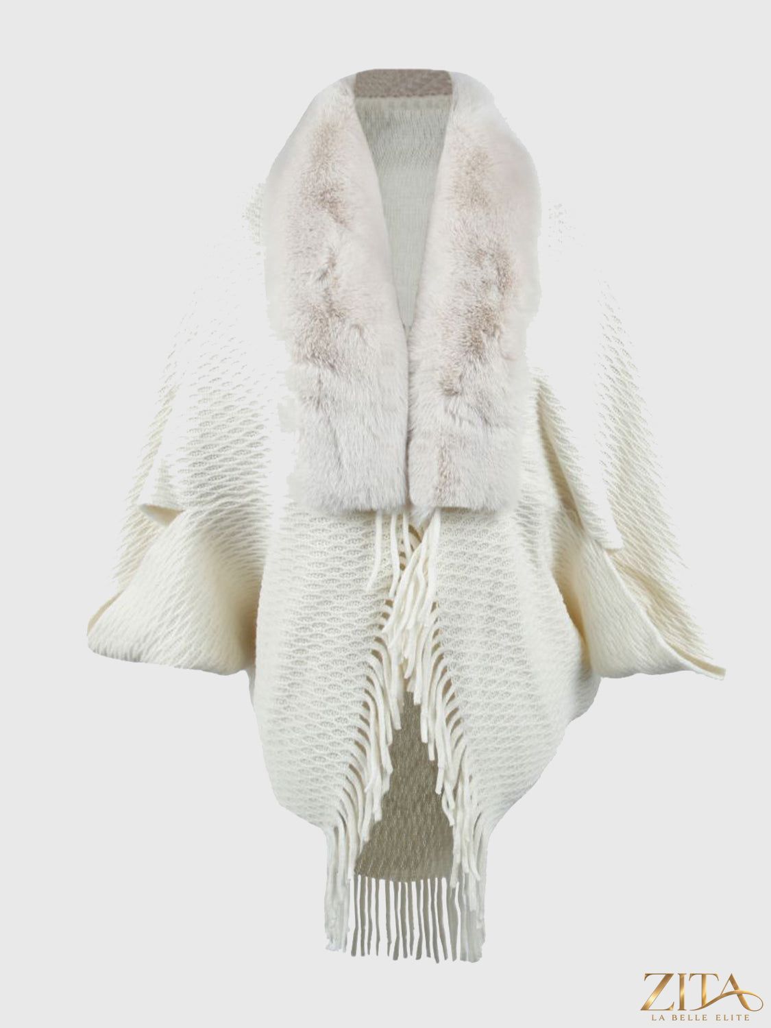 Open front fringe hem poncho with flowing fabric and tassel details, styled in neutral tones for a stylish layered look.