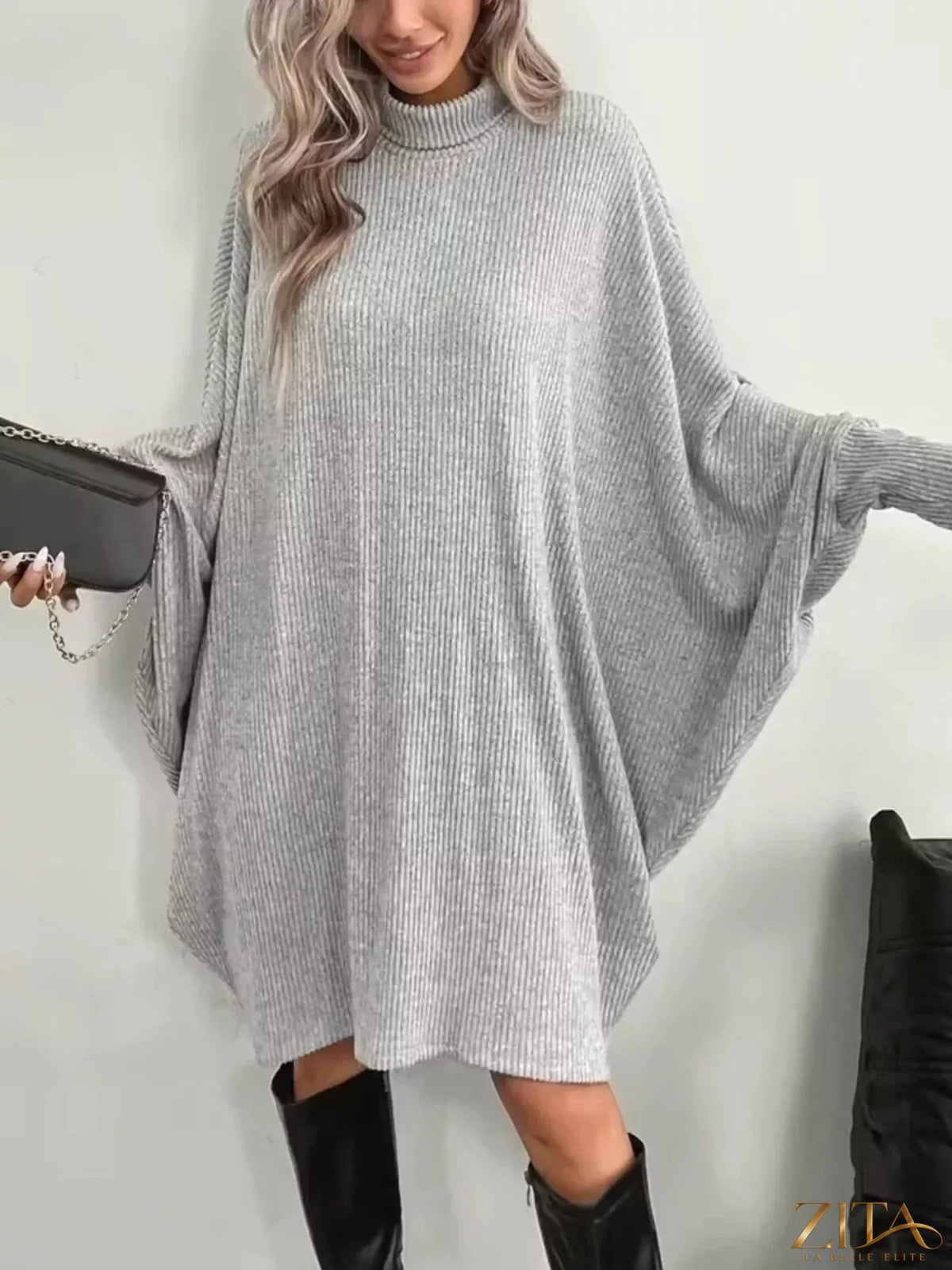 Zita La Belle Elite oversized batwing sleeve ribbed knit turtleneck dress in dark color, showing the relaxed fit and textured fabric.