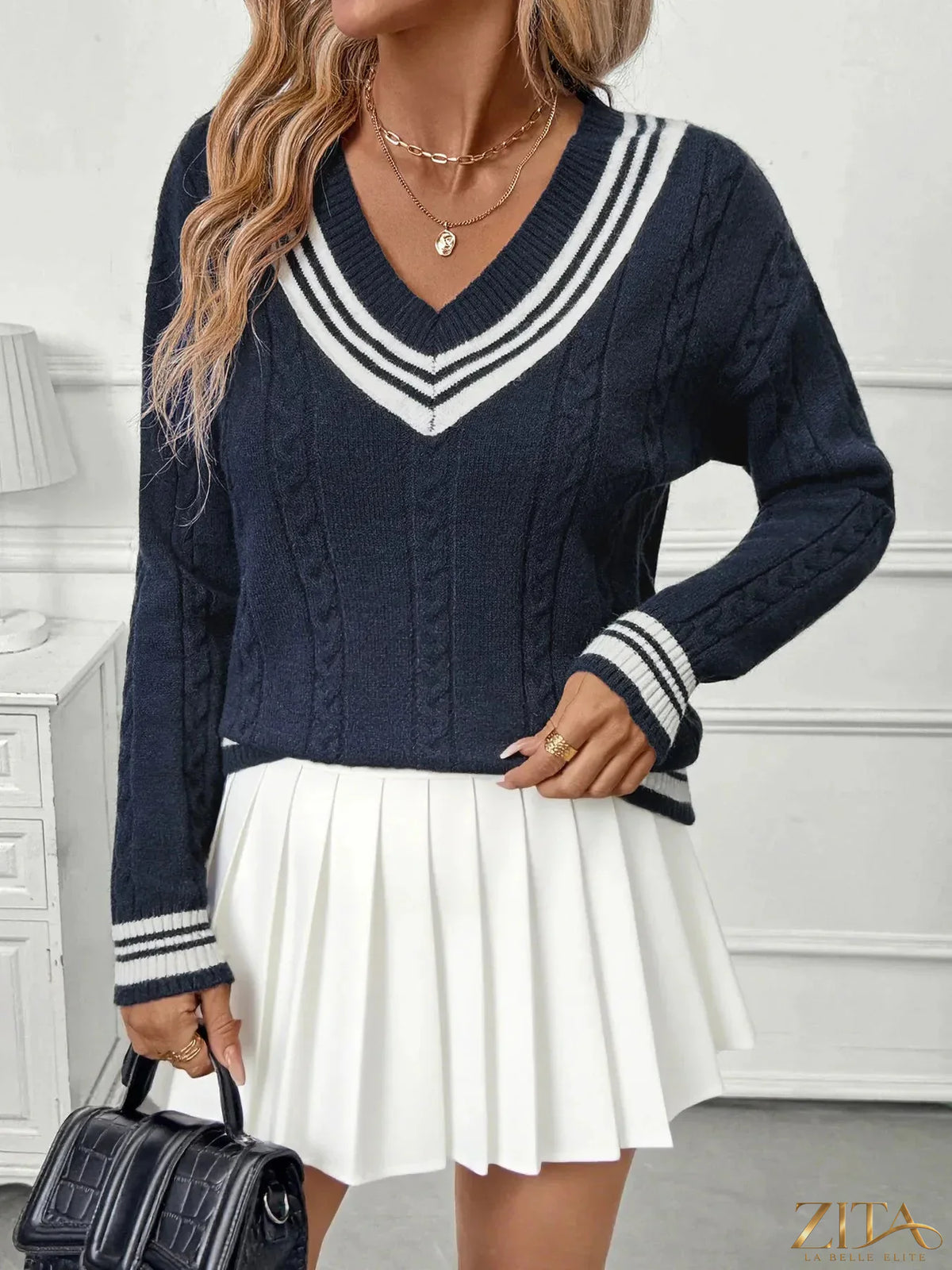 Contrast striped V-neck sweater by Zita La Belle Elite, featuring bold black and white horizontal stripes and a classic V-neck design.