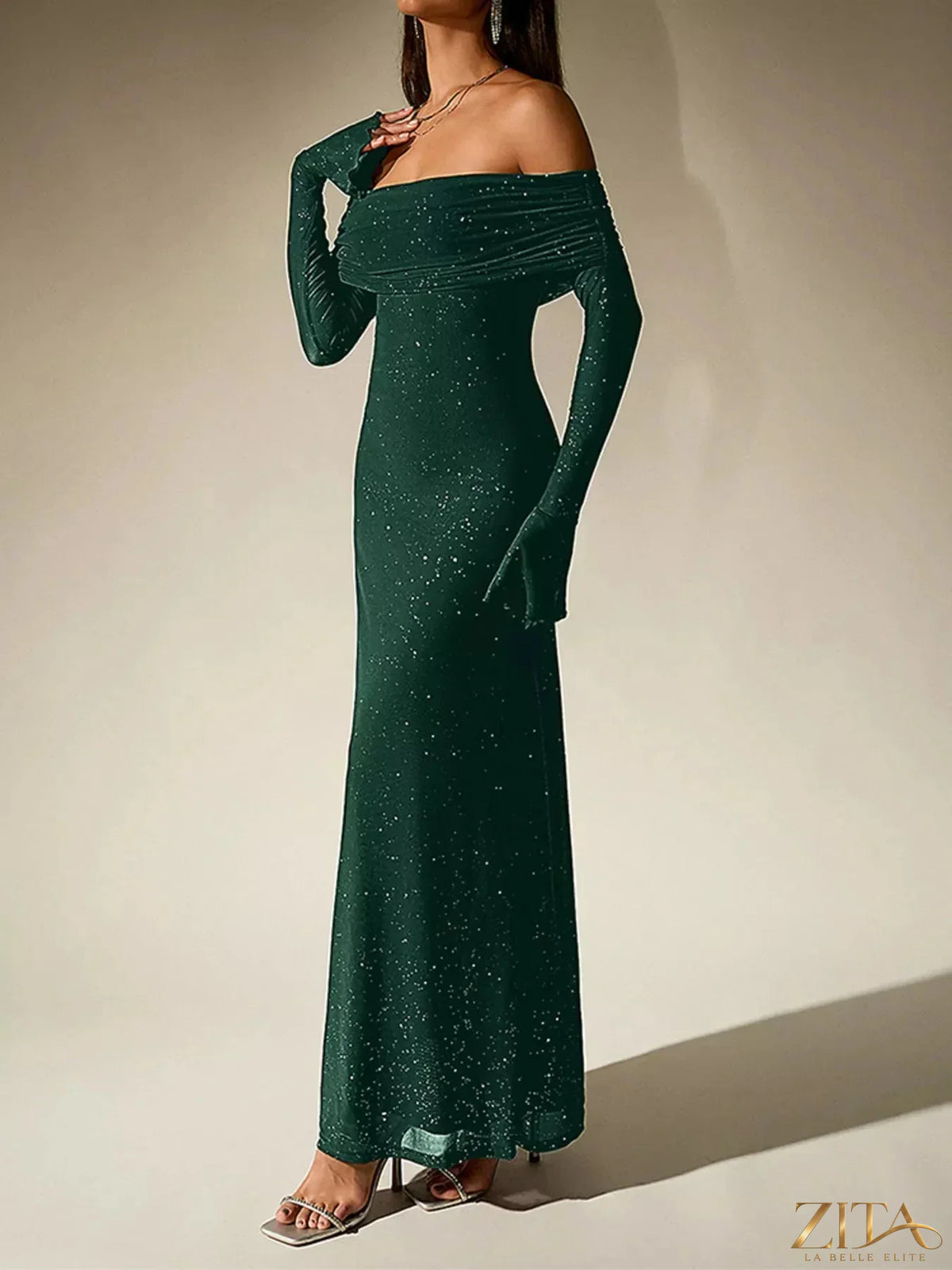 Zita La Belle Elite glitter off-shoulder maxi dress with flowing fabric and shimmering details, perfect for elegant evening wear.