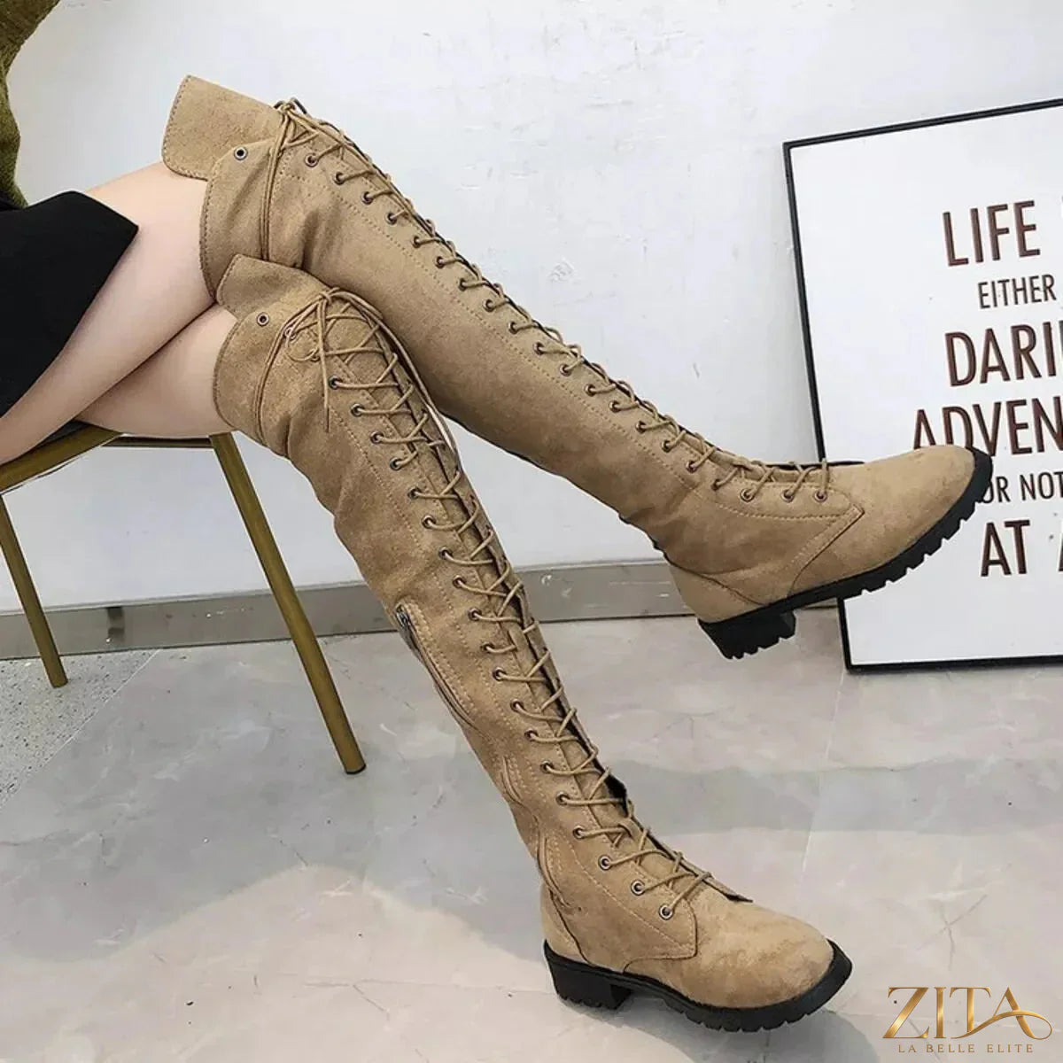 Over-the-knee lace-up boots by Trendsi featuring a sleek design and high heel, shown in black leather with laces up the front.