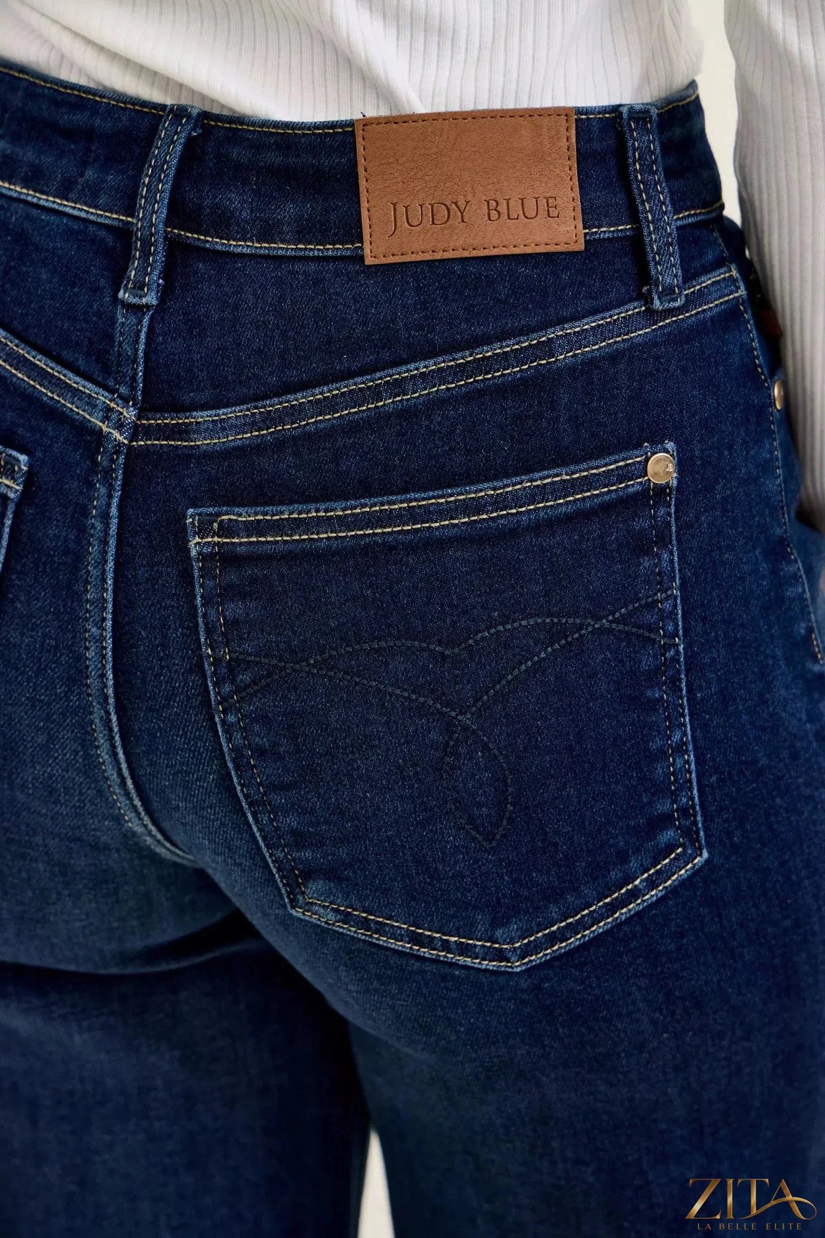 Dark wash Judy Blue high-waisted wide-leg jeans with classic denim texture and fit, styled by Zita La Belle Elite.
