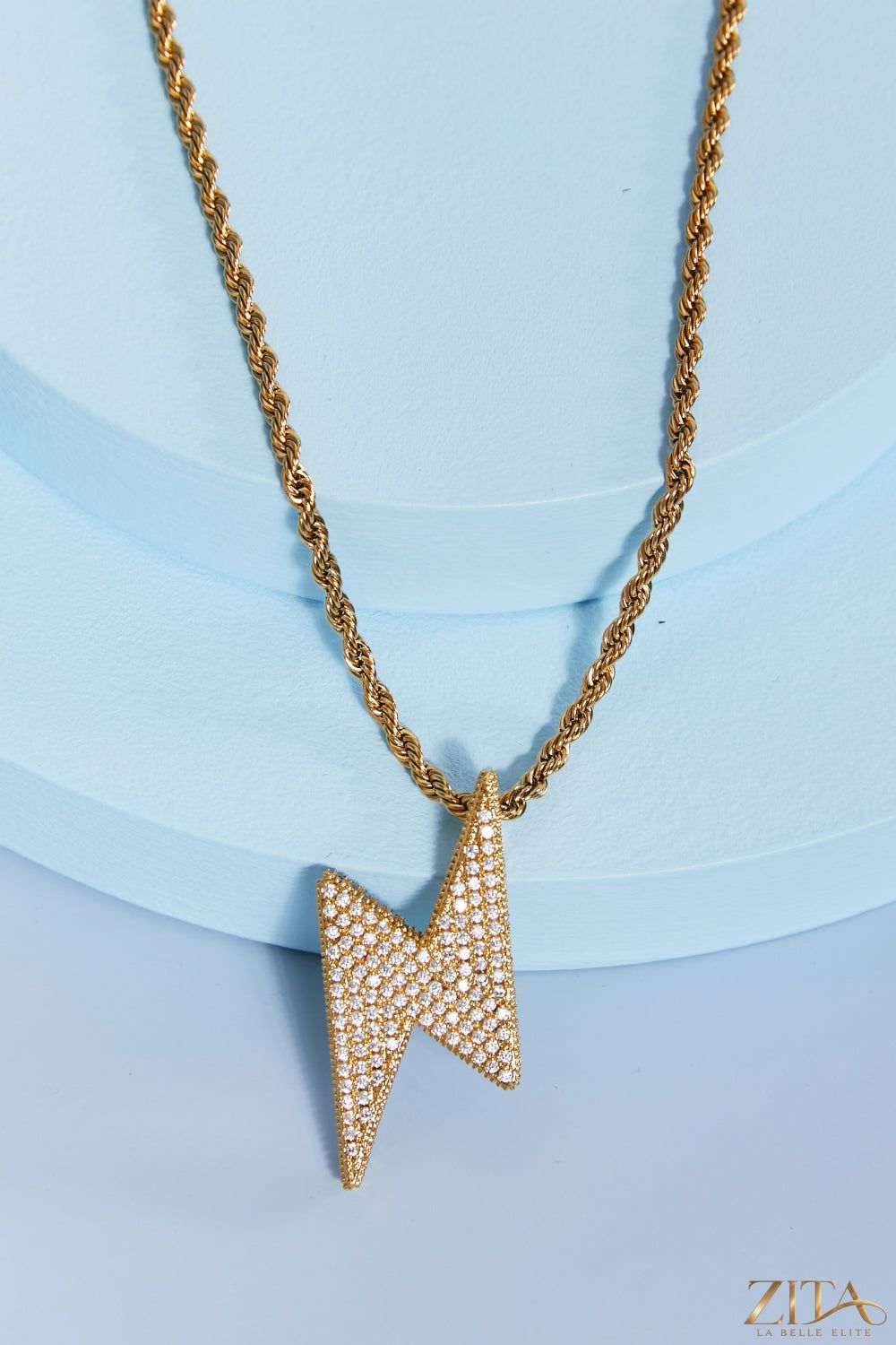 Brass lightning pendant necklace by Zita La Belle Elite featuring a sleek, metallic lightning bolt design on a chain.