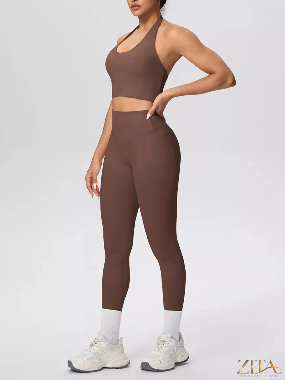Zita La Belle Elite halter neck crop top and high-waisted leggings active set, shown on a model in a fitness pose.
