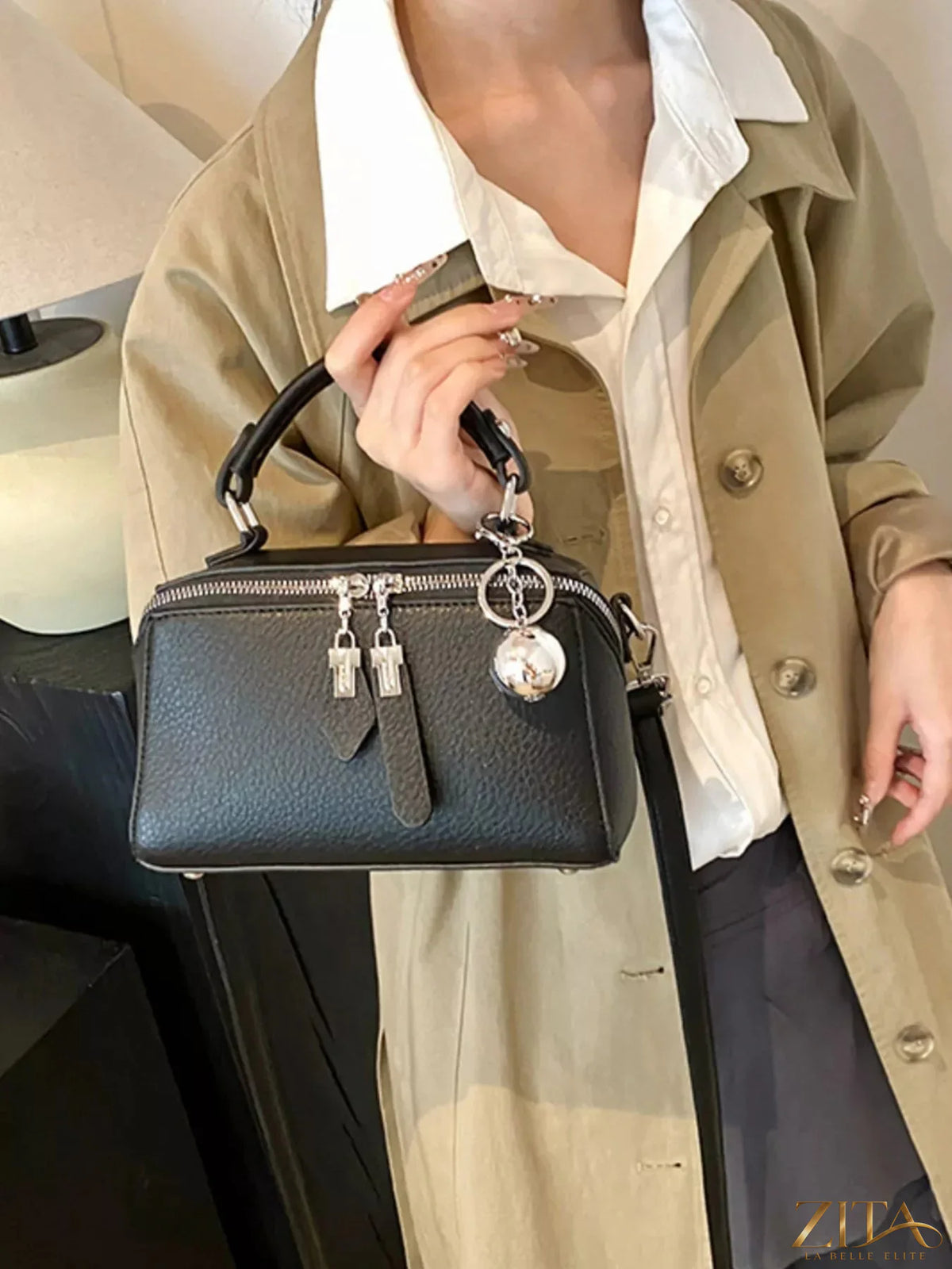 Textured leather handbag by Trendsi featuring a sleek design and top handle, showcasing detailed craftsmanship and rich material.