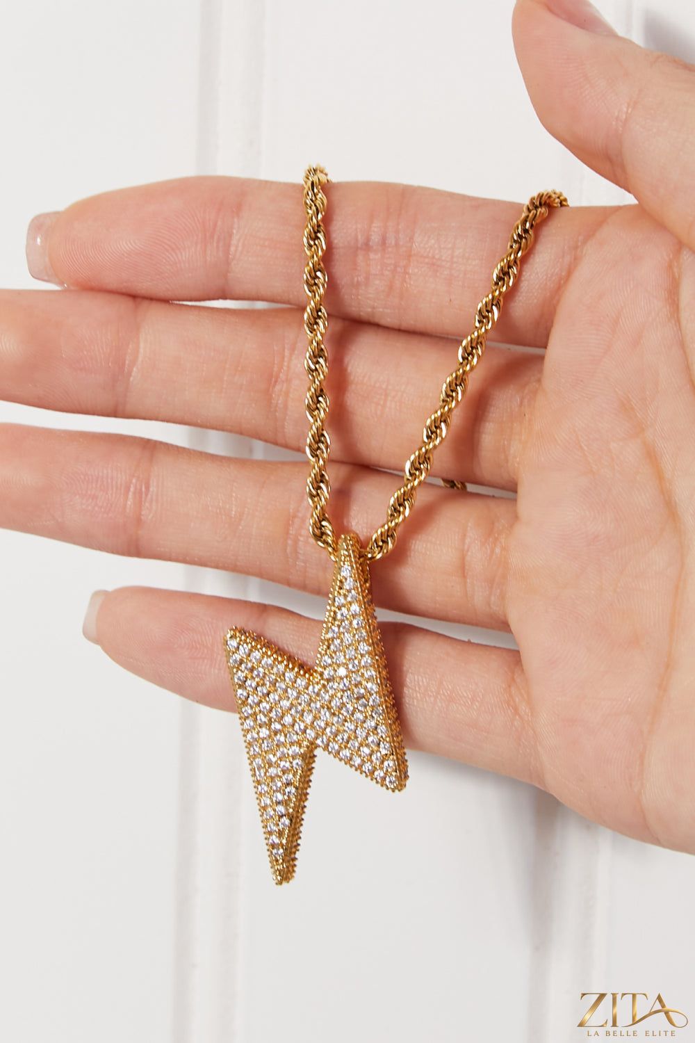 Brass lightning pendant necklace from Zita La Belle Elite featuring a bold, sleek lightning bolt charm on a delicate chain.