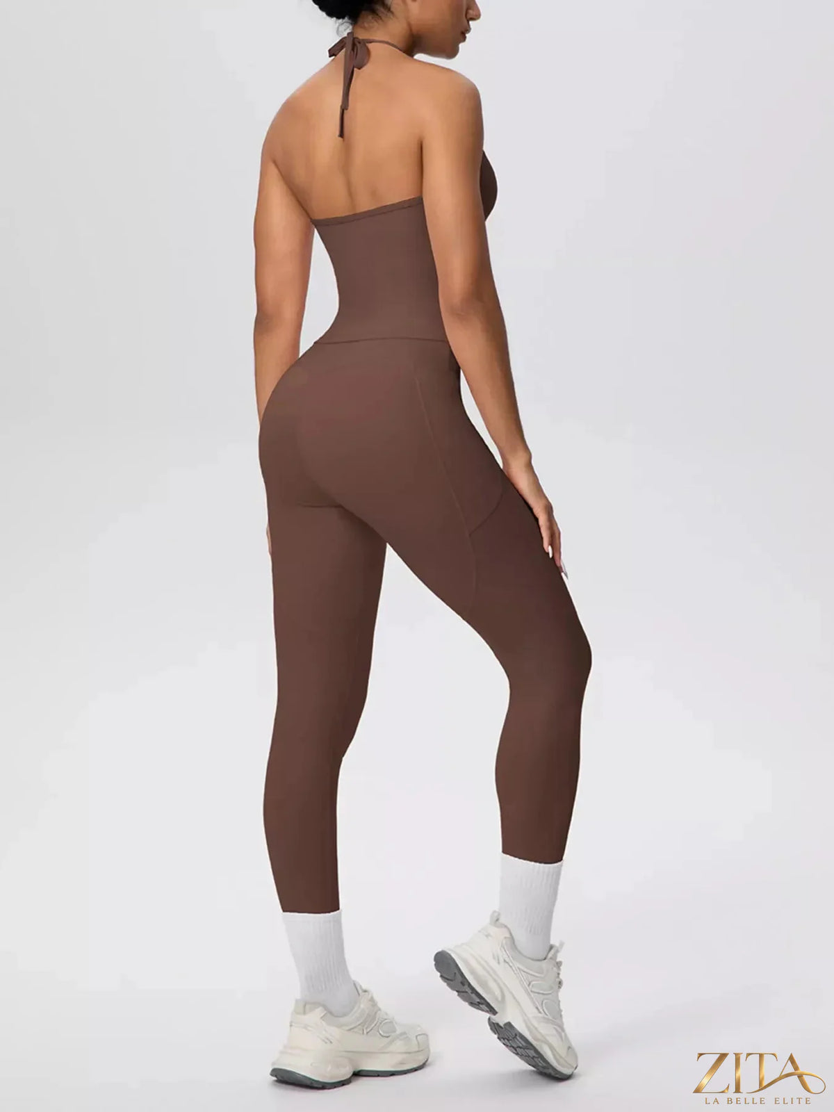 Zita La Belle Elite halter neck cami and high-waisted leggings active set, black, stretchy fabric, on a model posing in a fitness environment.