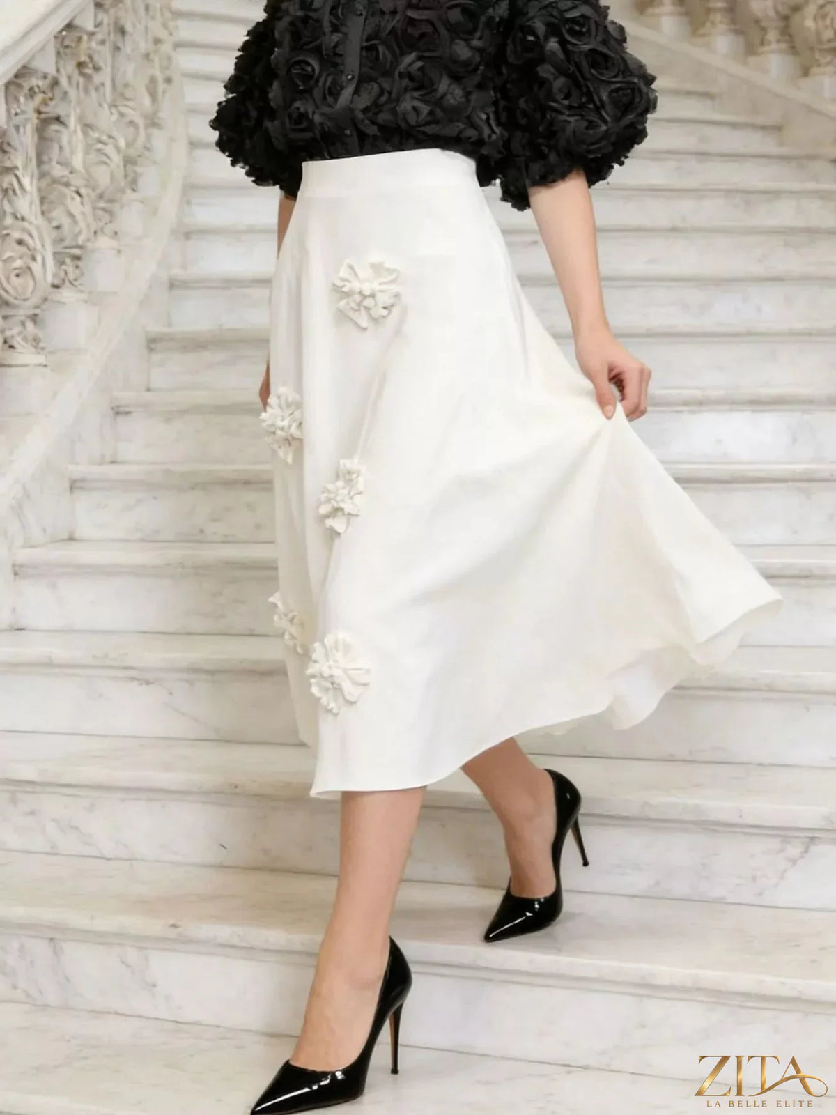 Floral embellished midi skirt from Trendsi featuring a flowy fabric with vibrant flower patterns and decorative embroidery.