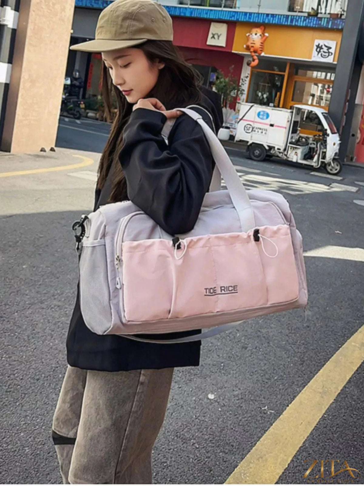 Zita La Belle Elite drawstring travel bag with multiple pockets, lightweight fabric, and adjustable strap for convenient travel storage.