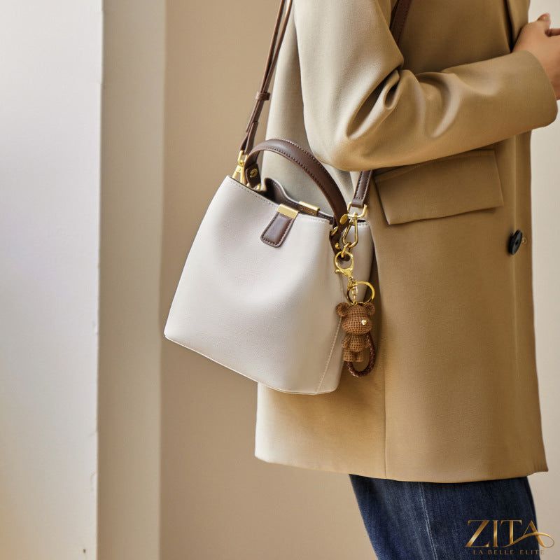 Leather bucket crossbody bag with adjustable strap and spacious interior, stylishly crafted by Trendsi.