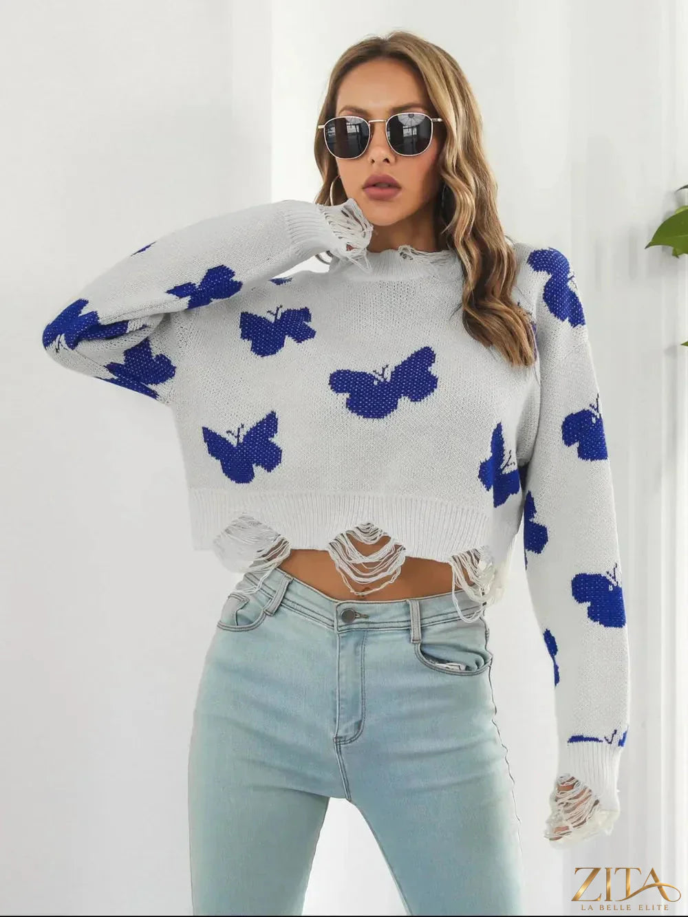 Zita La Belle Elite distressed butterfly cropped sweater featuring a worn look, ribbed cuffs, and a relaxed fit.