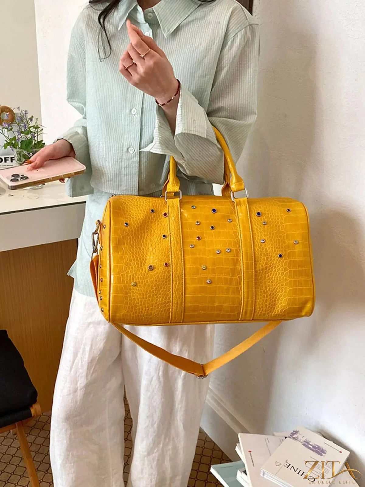 Zita La Belle Elite crocodile embossed studded travel bag with top handles and zip closure, showcasing textured leather and hardware details.