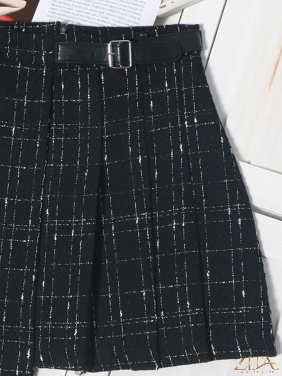 Zita La Belle Elite pleated plaid mini skirt with high waist and classic tartan pattern, styled on a model.