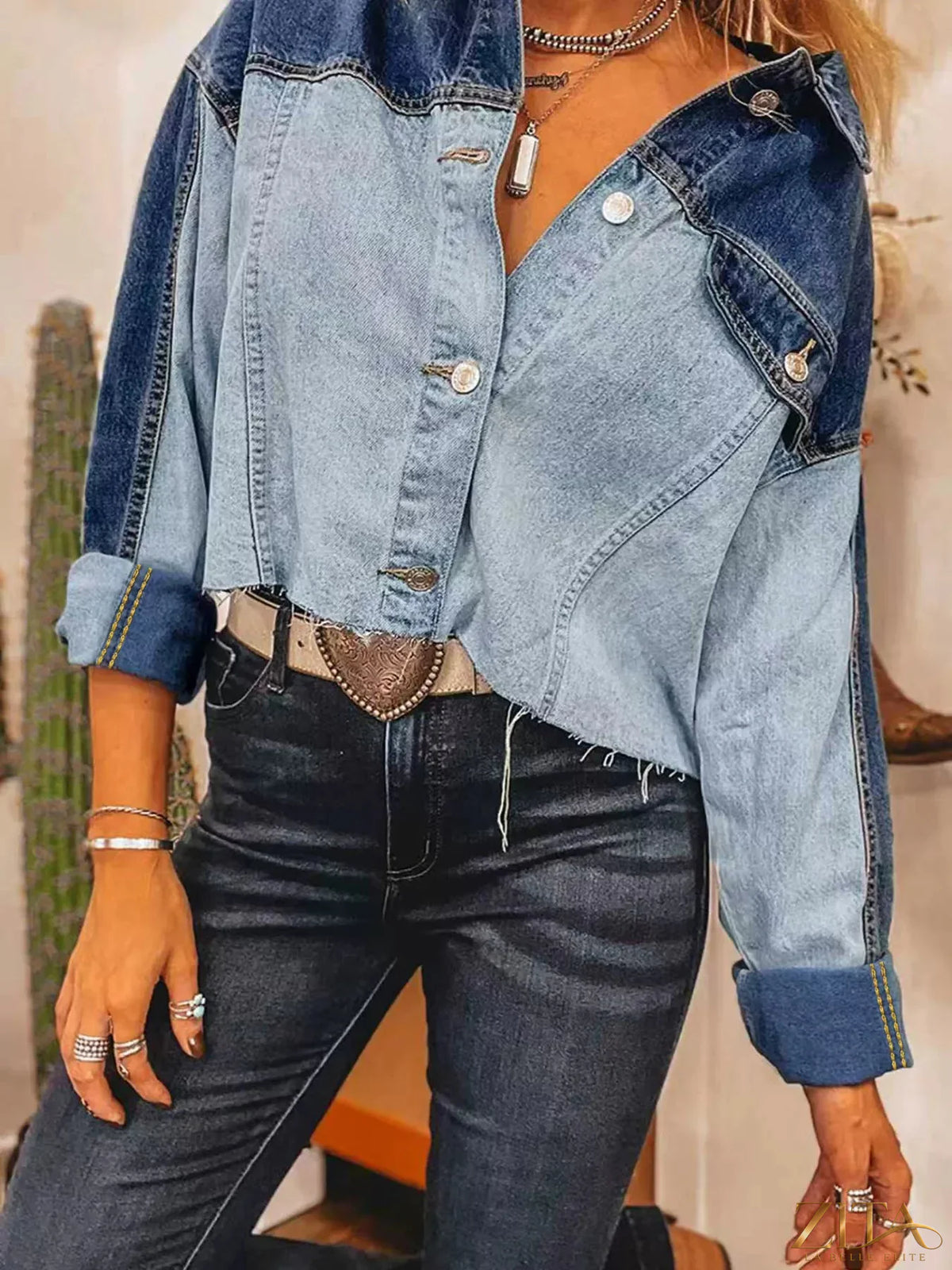 Raw hem two-tone denim jacket by Trendsi, featuring classic design with contrasting denim panels and button closure.