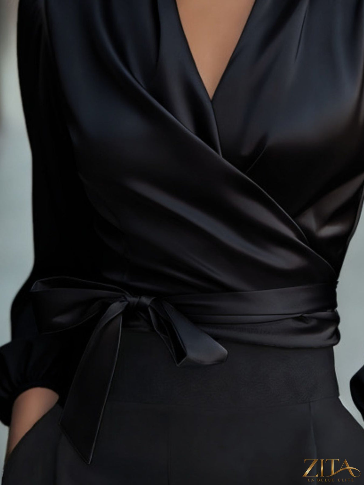 Zita La Belle Elite satin tie waist wrap blouse in soft fabric, featuring a V-neck and long sleeves, displayed on a model.