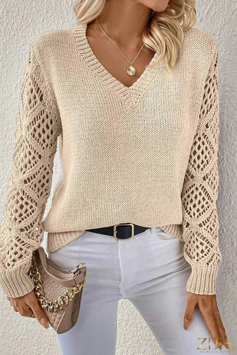 V-Neck crochet sleeve sweater by Trendsi, featuring a stylish V-neckline and intricate crochet sleeve details.