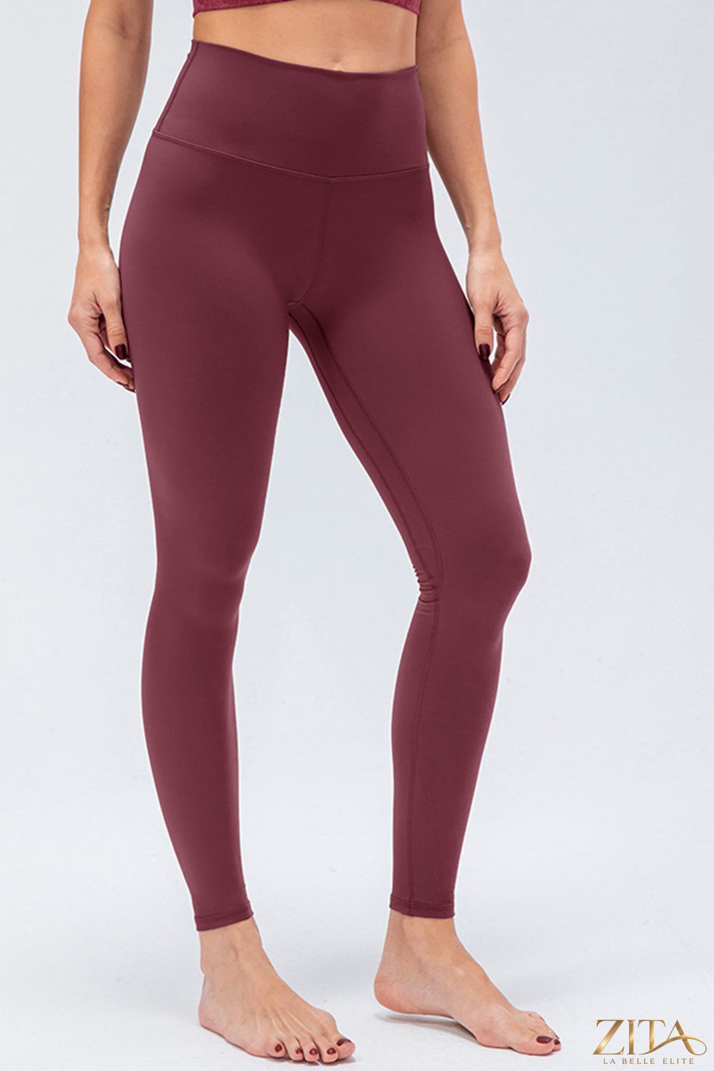 Slim fit active leggings with wide waistband by Trendsi, featuring a sleek design perfect for workouts and casual wear.
