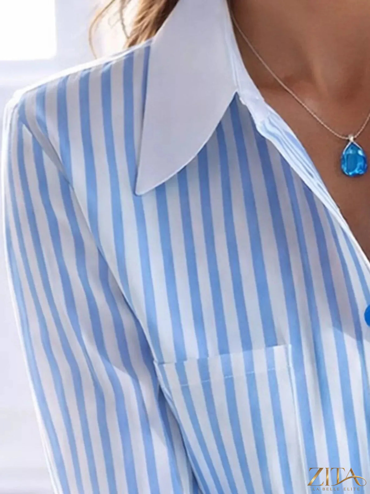 Zita La Belle Elite striped button-down shirt with blue and white vertical stripes, classic collar, and long sleeves.