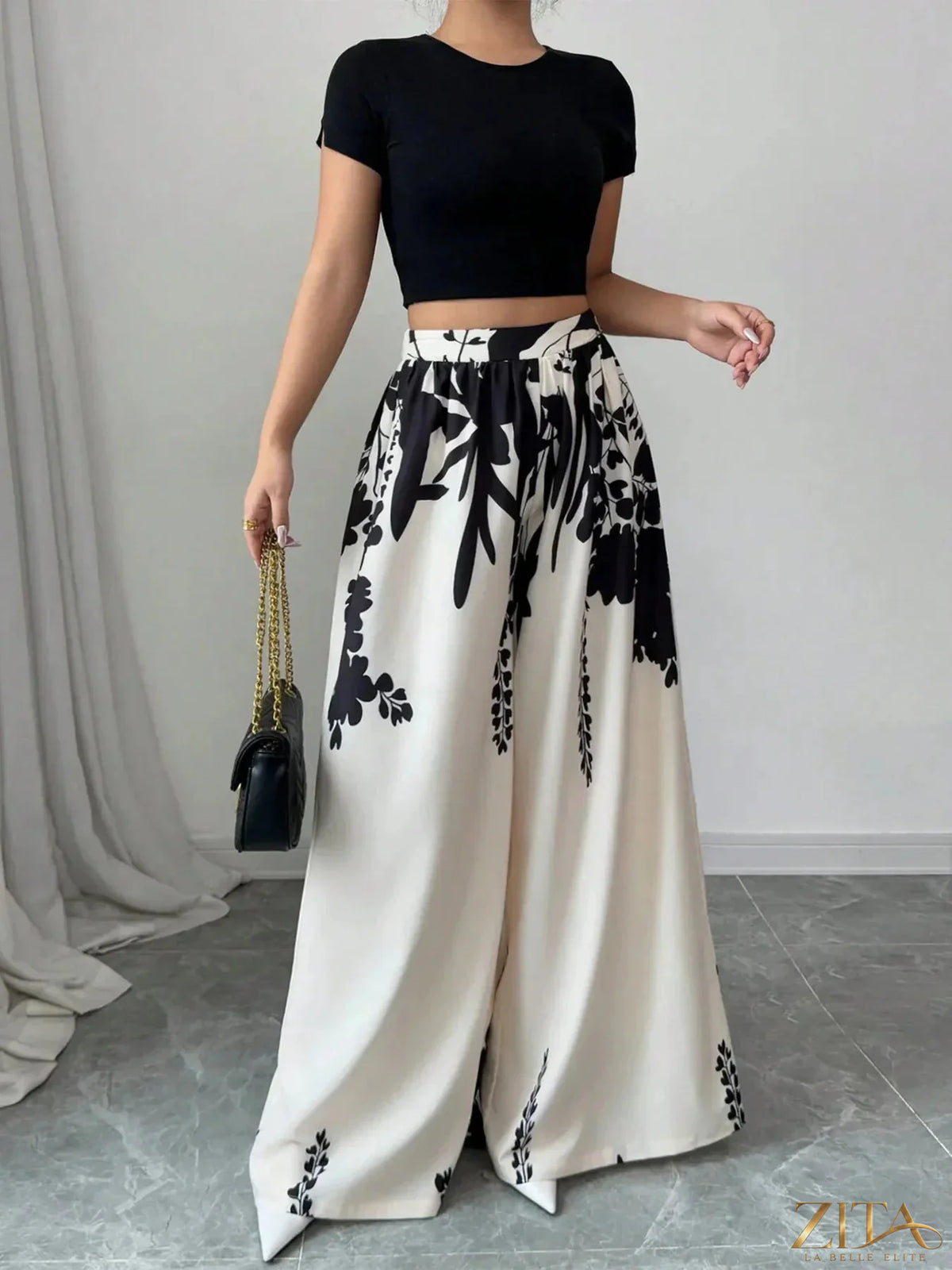 Printed wide leg pants by Zita La Belle Elite with a flowy silhouette and bold floral pattern, shown on a model.