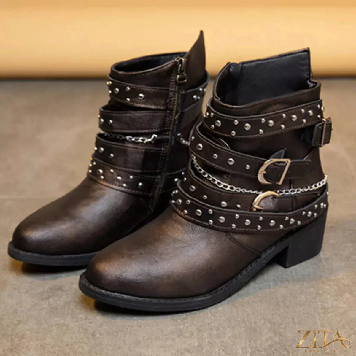 Zita La Belle Elite studded buckle ankle boots with leather straps and metal buckle detail on black leather surface.