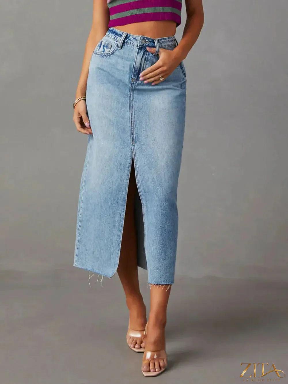 Zita La Belle Elite raw hem front slit denim midi skirt shown on a model with a casual outfit, showcasing its stylish design and fit.
