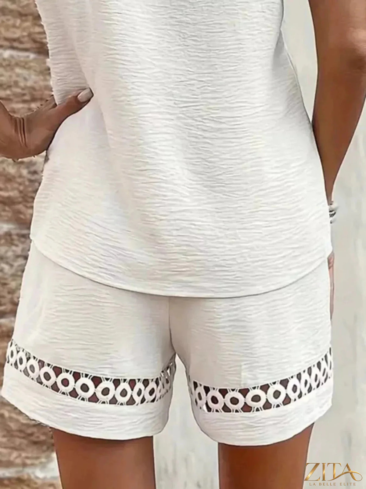 Lace trim V-neck top and matching shorts two-piece set by Trendsi, featuring delicate lace details and comfortable fit.