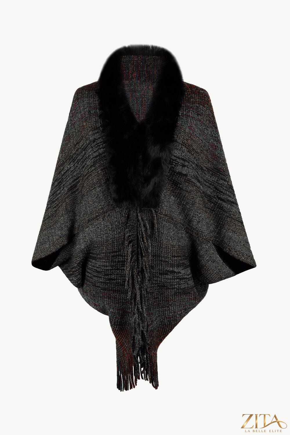 Open front fringe hem poncho in neutral fabric with tassel details, stylishly draped on a hanger.