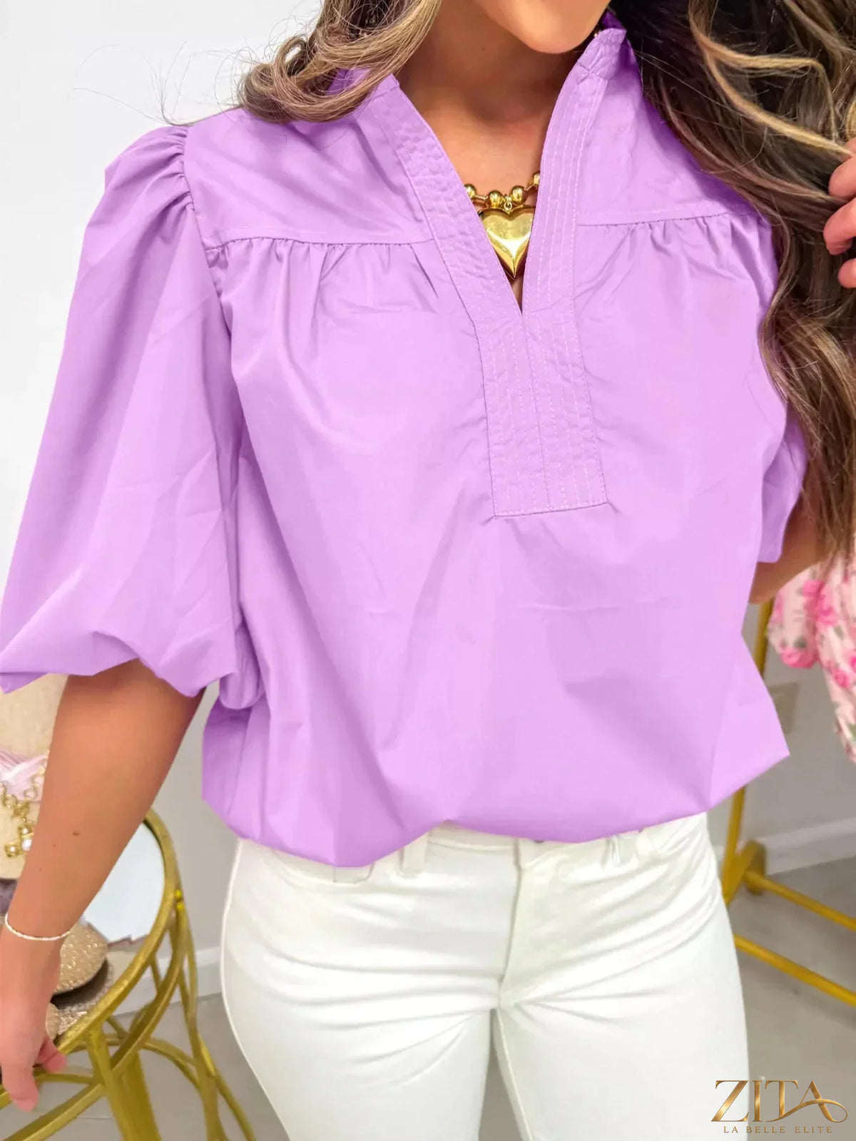 Zita La Belle Elite notched puff sleeve blouse with ruffled details and a fitted design, shown on a mannequin.