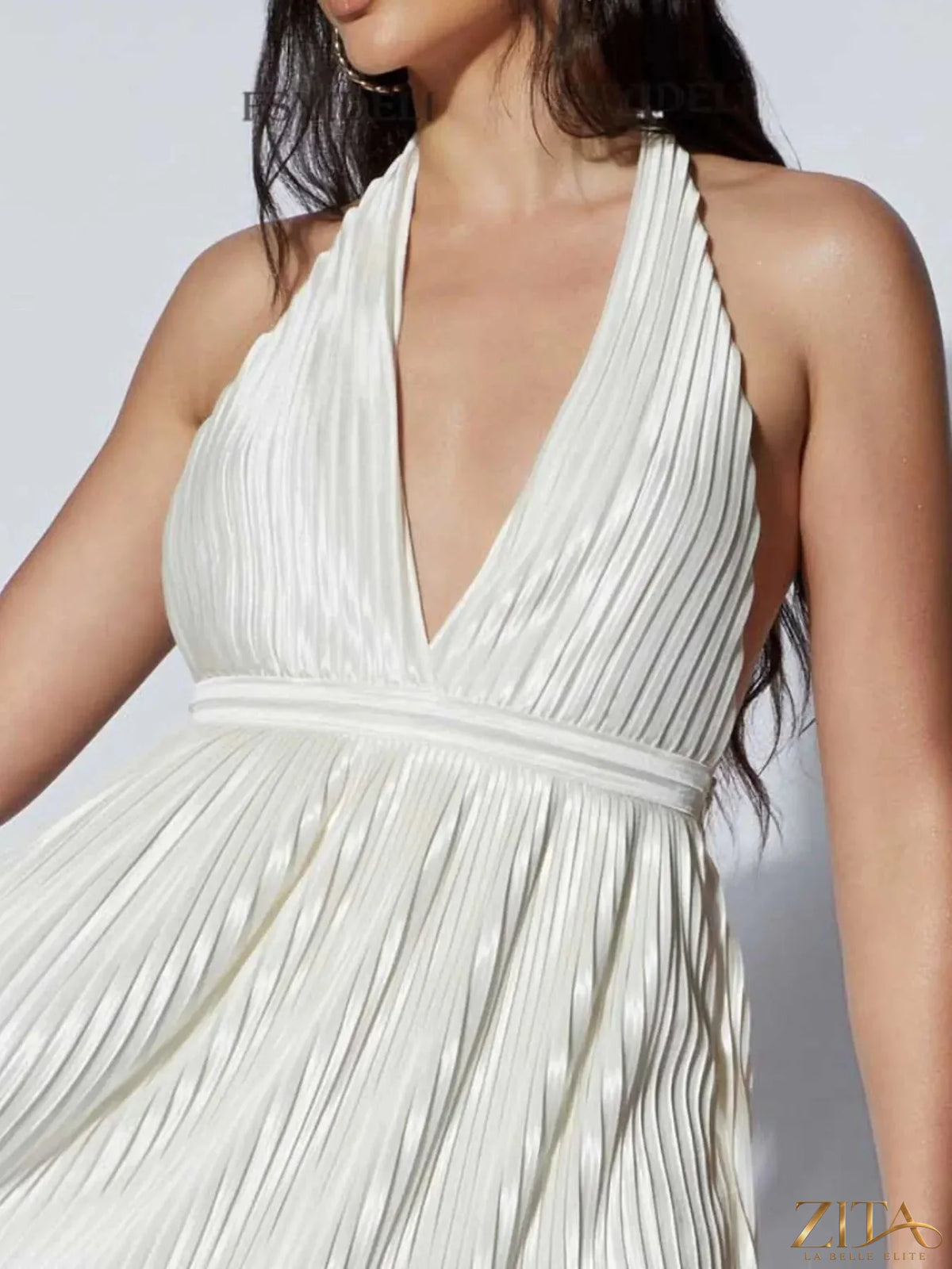 Pink pleated halter neck mini dress from Trendsi featuring a fitted bodice and flared skirt, perfect for summer events.