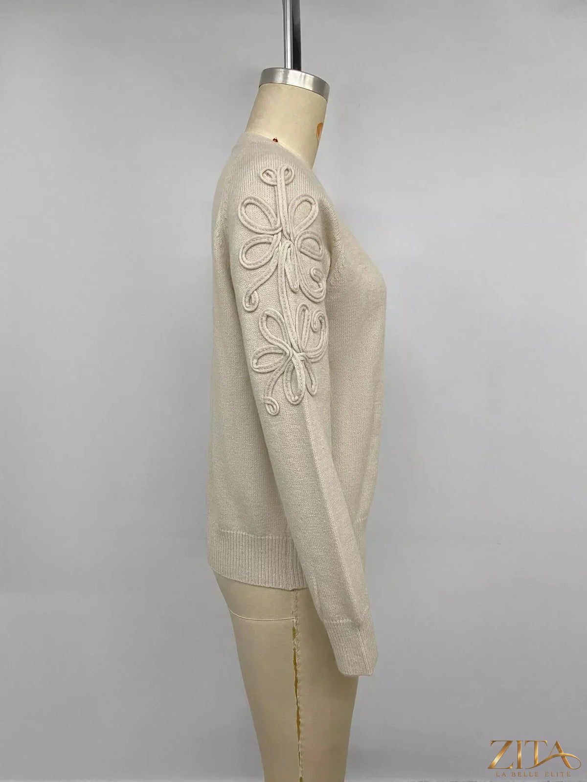 Floral raglan sleeve sweater by Trendsi featuring a cozy knit design with colorful floral accents on the sleeves.