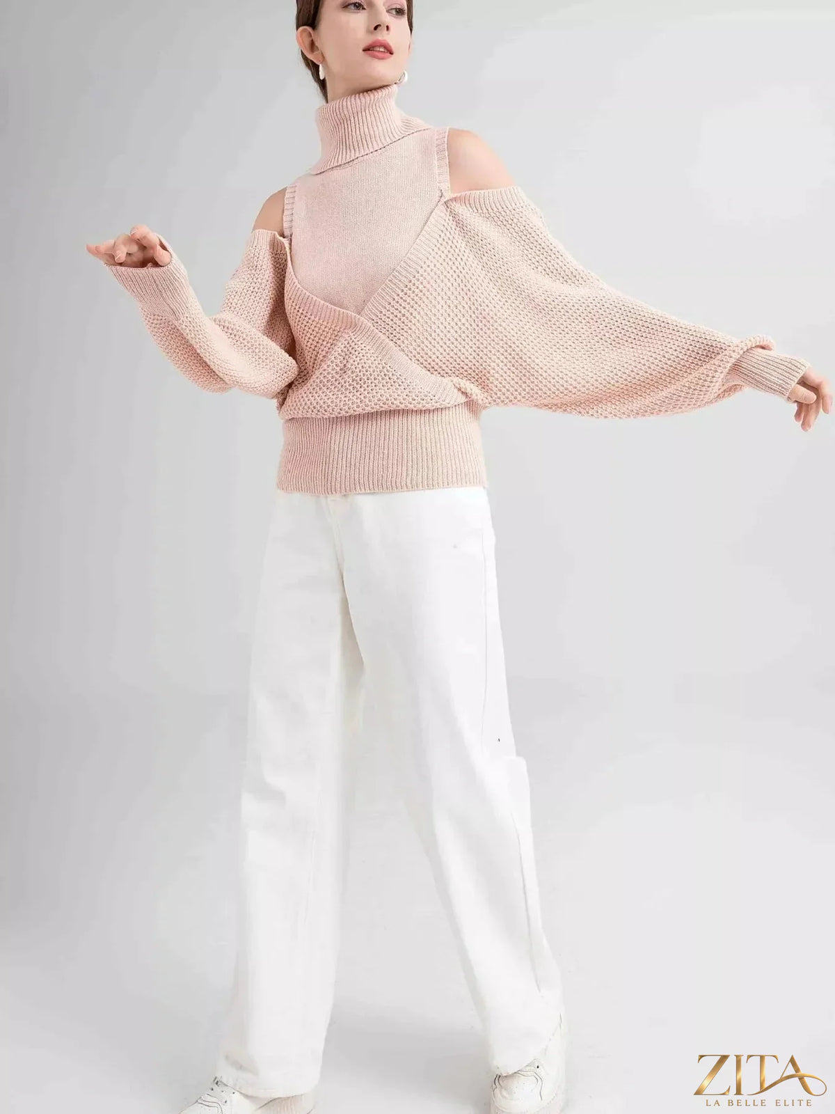 Waffle knit cold shoulder turtleneck sweater by Trendsi featuring a cozy design with cut-out shoulders and a high turtleneck.