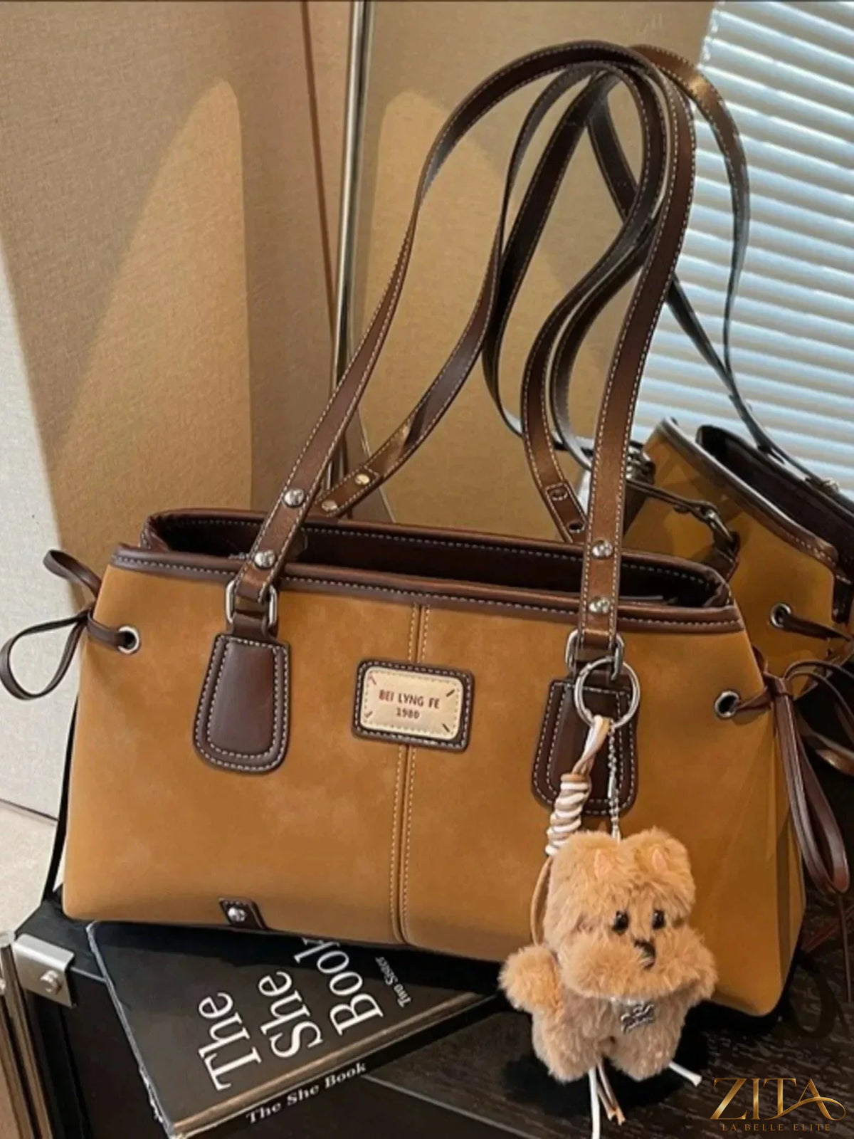 Zita La Belle Elite side tie shoulder bag with sleek design and adjustable strap, shown in a stylish close-up image.