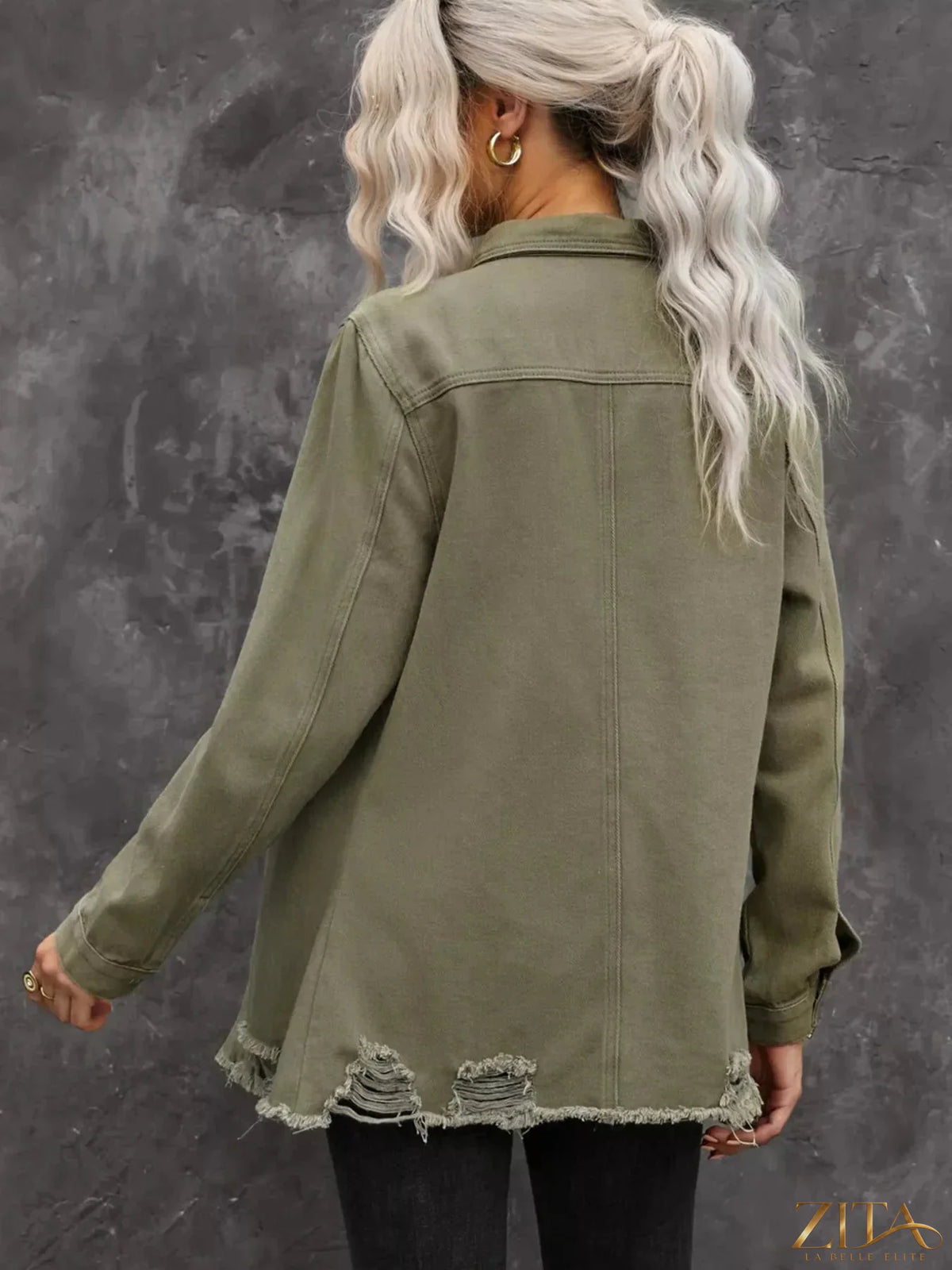 Zita La Belle Elite raw hem distressed denim shirt jacket with frayed edges and casual fit, displayed on a hanger.